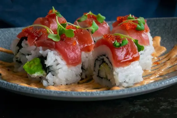 Tuna topped maki rolls will make there way to your table on a conveyor belt.