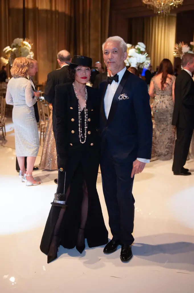 Duyen Nguyen in Balmain with St. Laurent cocktail hat & Marc Nguyen (Photo by Wilson Parish)