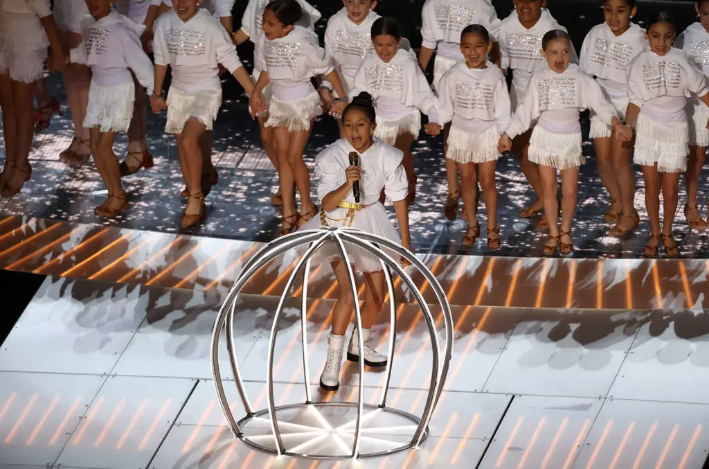 Jennifer Lopez's 11-year-old daughter, Emme Maribel-Muniz, popped out of a cage during a powerful Super Bowl halftime.