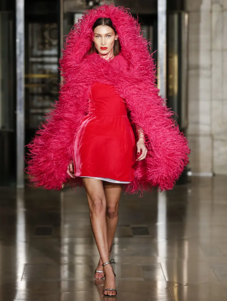 Oscar de la Renta feather hooded cape, milk velvet dress, crystal tie ankle sandal. (Photo courtesy of Oscar de la Renta)