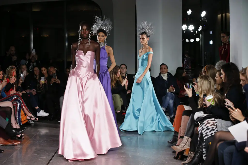 Naeem Khan closed his runway show with a series of satin gowns and Statue of Liberty headdresses. (Photo by Dan and Corina Lecca)