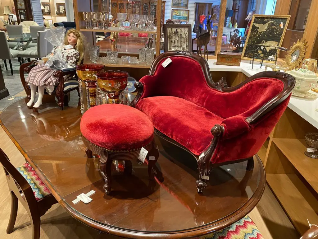 An antique doll and Victorian children's furniture are among the many finds at the Blue Bird Circle Resale Shop. (Photo by Shelby Hodge)