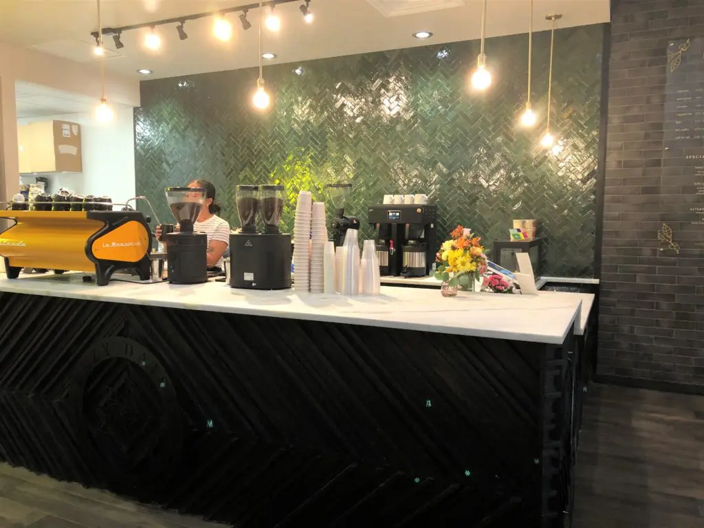 Lazy Daisy's stylish coffee bar backed by green herringbone tiles(photo by Courtney Dabney).