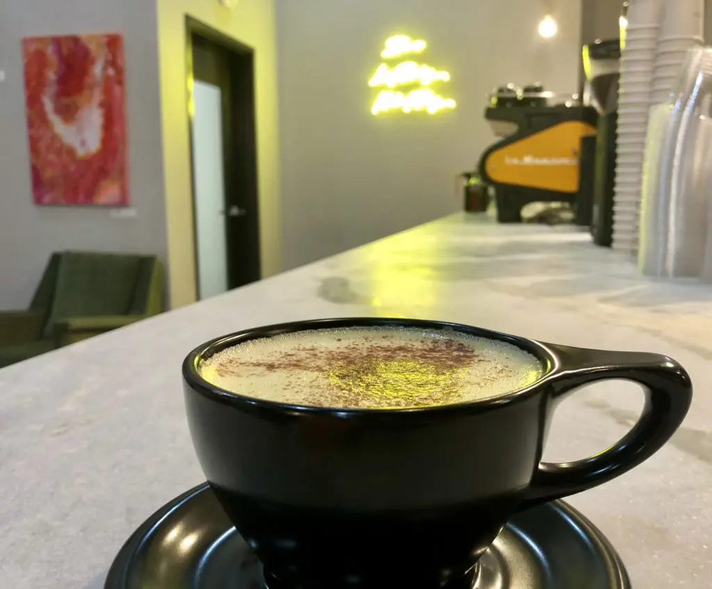 Lazy Daisy's Golden Milk Chai Latte glows by neon light (Photo by Courtney Dabney).