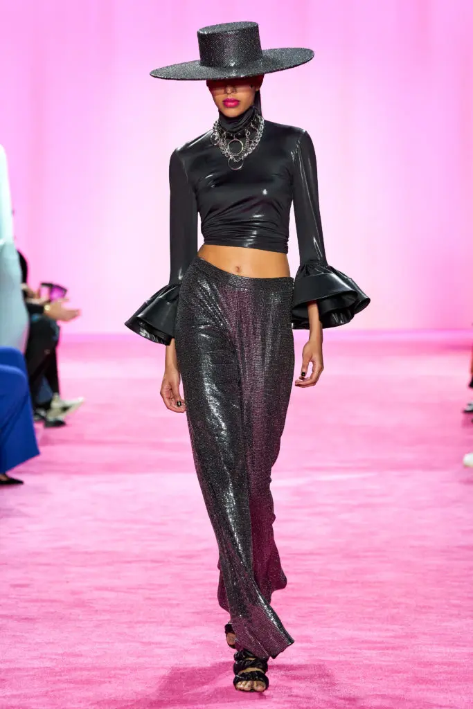 Christian Siriano black bell sleeve turtleneck top and sequin shimmer trousers. (Photo courtesy of Imaxtree)