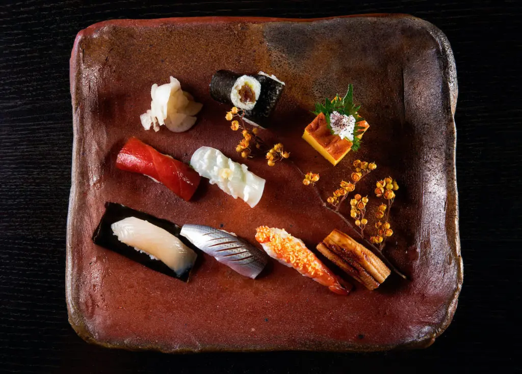 A selection of edomae sushi at Tei-An in Dallas. Top row, kanpyu maki (salted gourd roll) and tamago (sweet omelet). Second row, zuke maguro (tuna) and yari ika (squid). Bottom row, hirame kobujime (flounder), kohada, kuruma ebi (shrimp), and anago (sea eel). (Photo by Kevin Marple)