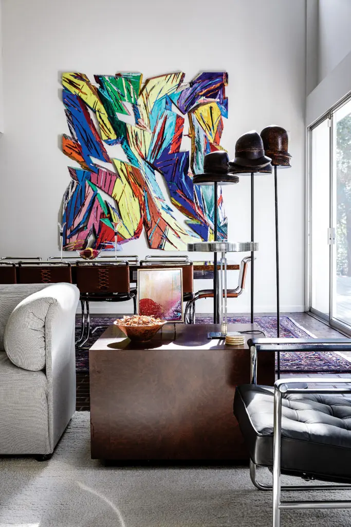 Wooden hat forms collected by the Brochsteins during a buying trip in France; Walsh designed their stands and arranged them as Surrealist sculpture. Eleanor Le Maire marquetry cube table fabricated at Brochsteins. L.A. artist Charles Arnoldi’s dramatic painting, circa 1980s, meticulously sited in the dining area by Walsh. (Photo by Pär Bengtsson)
