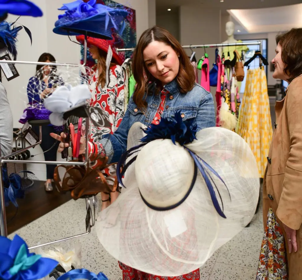 Jayne Johnston checks out the Kentucky Derby-ready hats at the Tootsies fashion event for Bo's Place. (Photo by Daniel Ortiz)