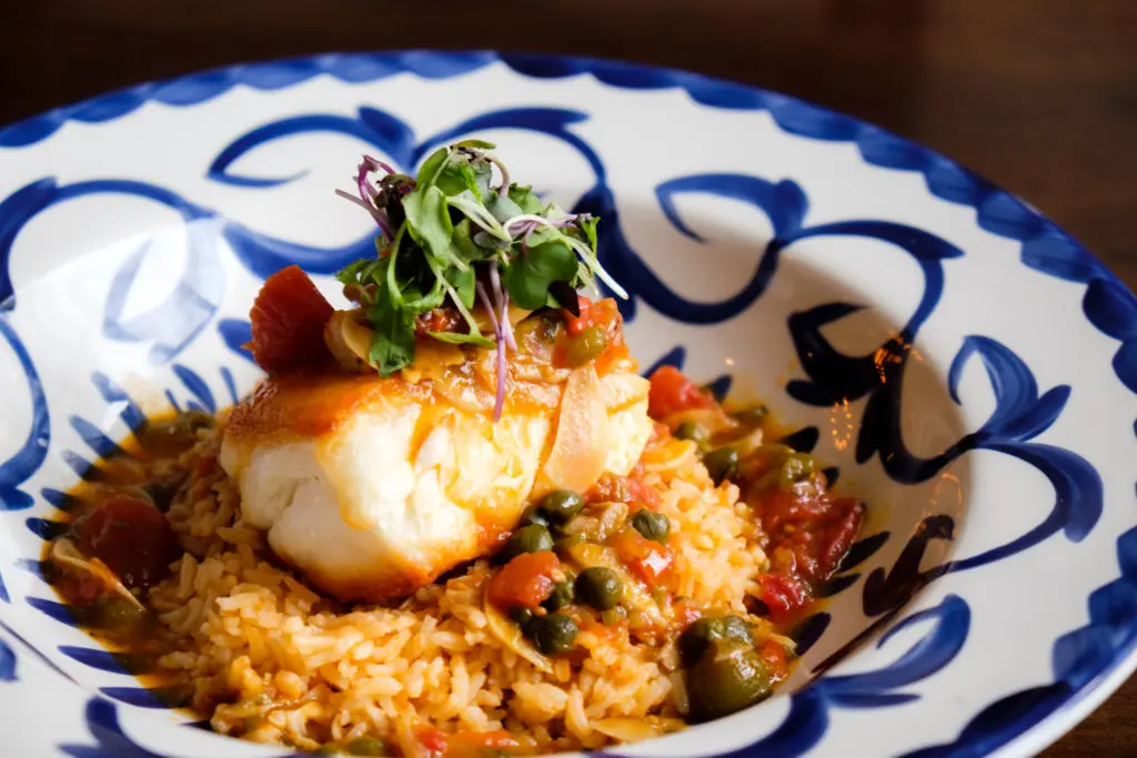 Sea Bass Veracruz with capers, olives and crispy garlic.