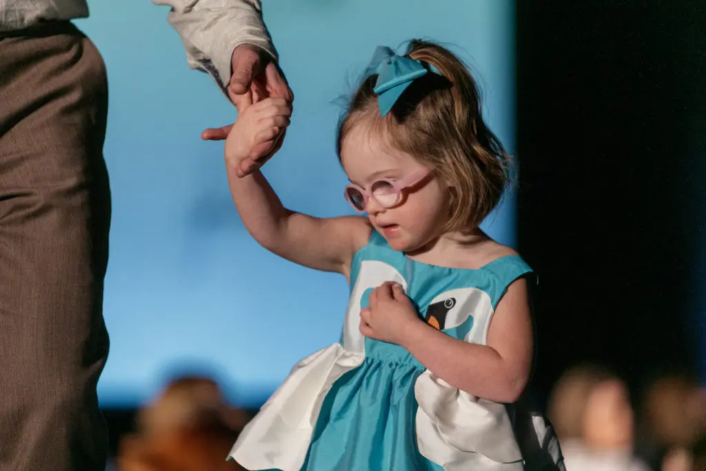 Modeling a Little Goodall Swan Dress at Runway for Rise. 