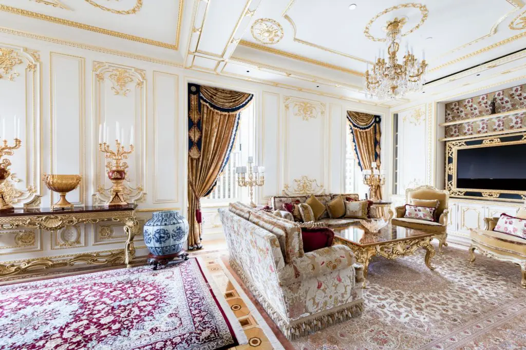 The great room at this Plaza Residence features lavish appointments, including gilded wall paneled, crystal chandeliers, and dramatic inlaid floors. (Photo  Courtesy Douglas Elliman ) (Photo by Douglas Elliman )