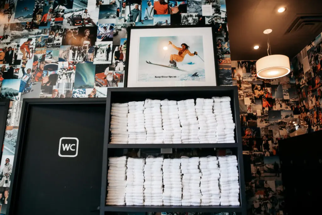 The walls are absolutely covered in cool vintage or editorial portraits evoking alpine culture, including several classic "Lange Girl" posters.