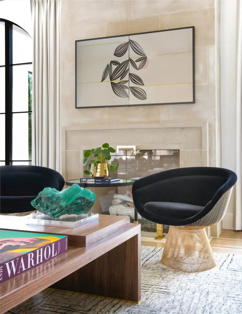 The living room's custom walnut coffee table is designed to pull apart as needed for more intimate gatherings. Lee Jofa chairs, Ralph Lauren light fixture. (Photo by Costa Christ Media)