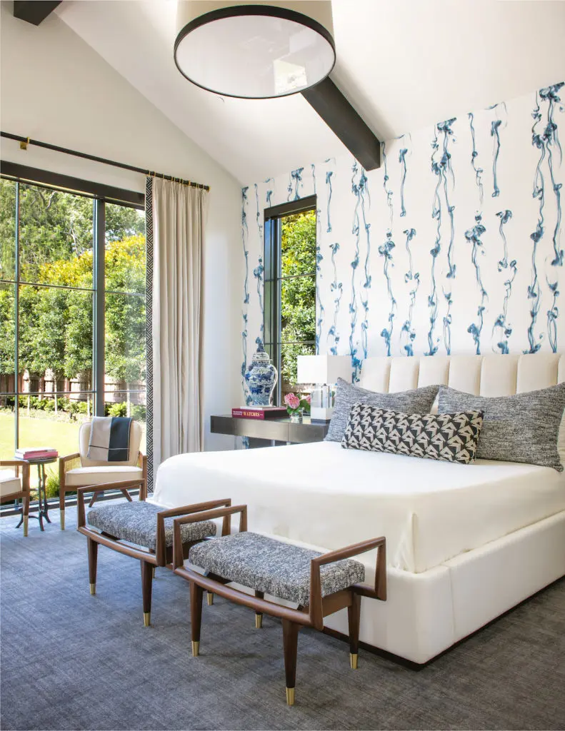 In this Preston Hollow home, designed by  Philip Thomas Vanderford and Jennifer Klos, the master bedroom's Trove wallpaper features gray puffs of smoke, and the custom benches are based on vintage designs. (Photo by Costa Christ Media)