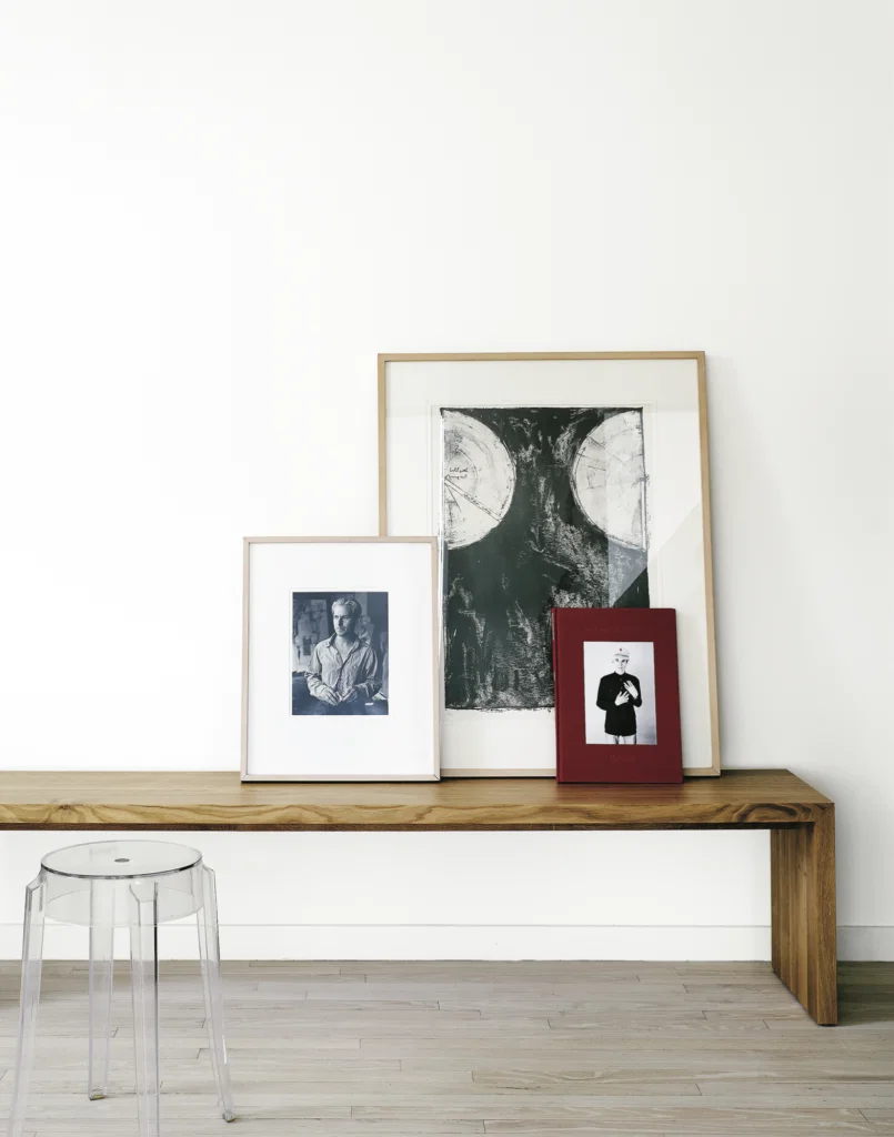 Barbara Davis, published April 2016. Photographed by Casey Dunn. In gallerist Barbara Davis' high-rise home, carefully edited furniture placed in dialogue with works of art. Ligne Roset Eaton bench. Philippe Stark Charles Ghost stool, from Sunset Settings. Art, from left: William de Kooning, 1980s; Jasper Johns print; Andy Warhol book. 