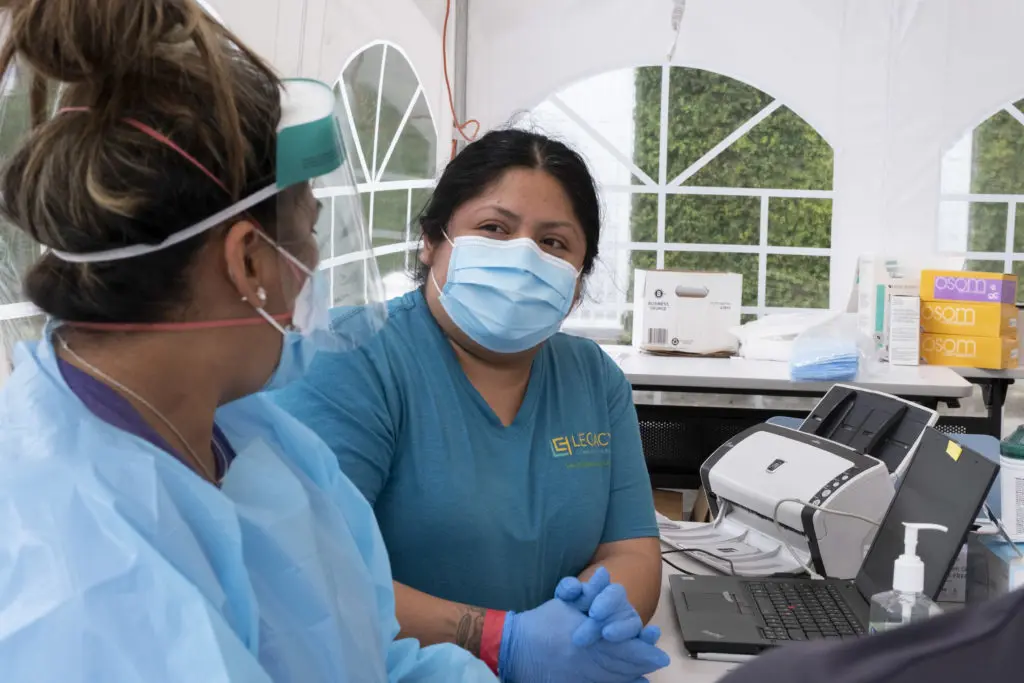Health care workers wearing personal protection equipment (PPE) get ready to test for the coronavirus at Legacy Community Health, Montrose. (Photo by F. Carter Smith)