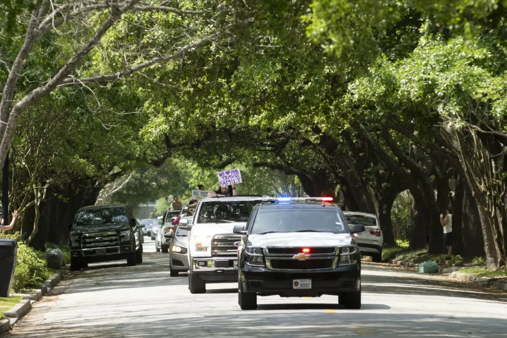 Teachers from Travis Elementary School parading through The Heights received a nice escort. (Photo by F. Carter Smith)