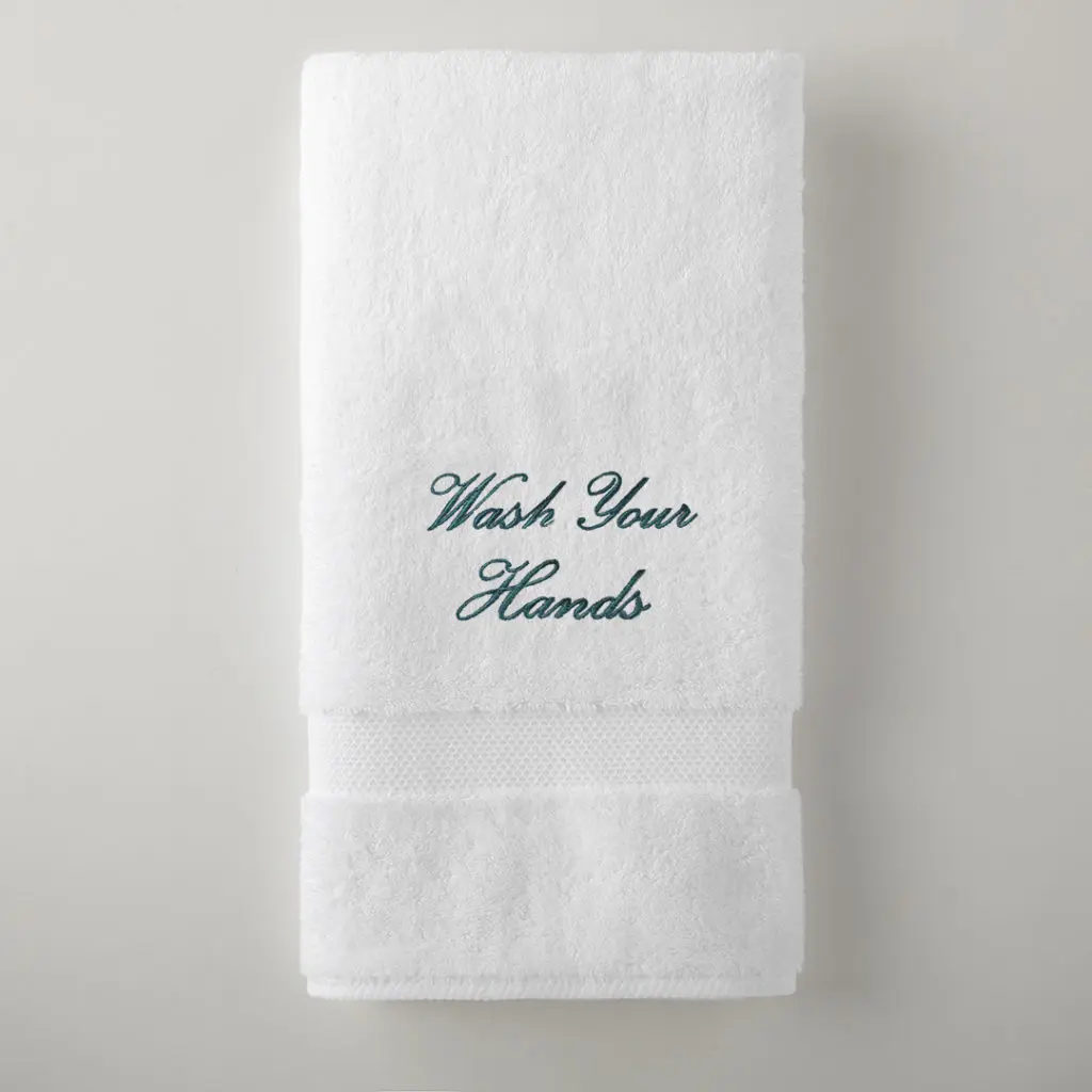 Grange bath towel embroidrerd with "Wash Your Hands" is $25. All proceeds to to funding Peacock Alley's mask-making efforts.