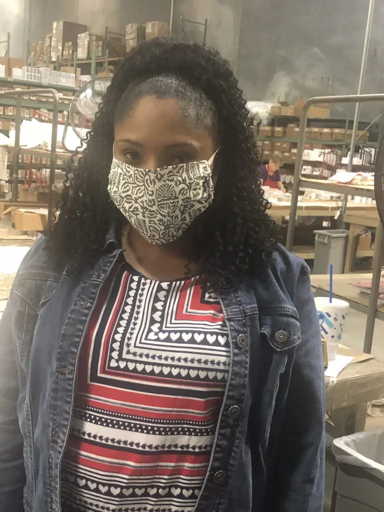 A Schumacher employee dons a mask.