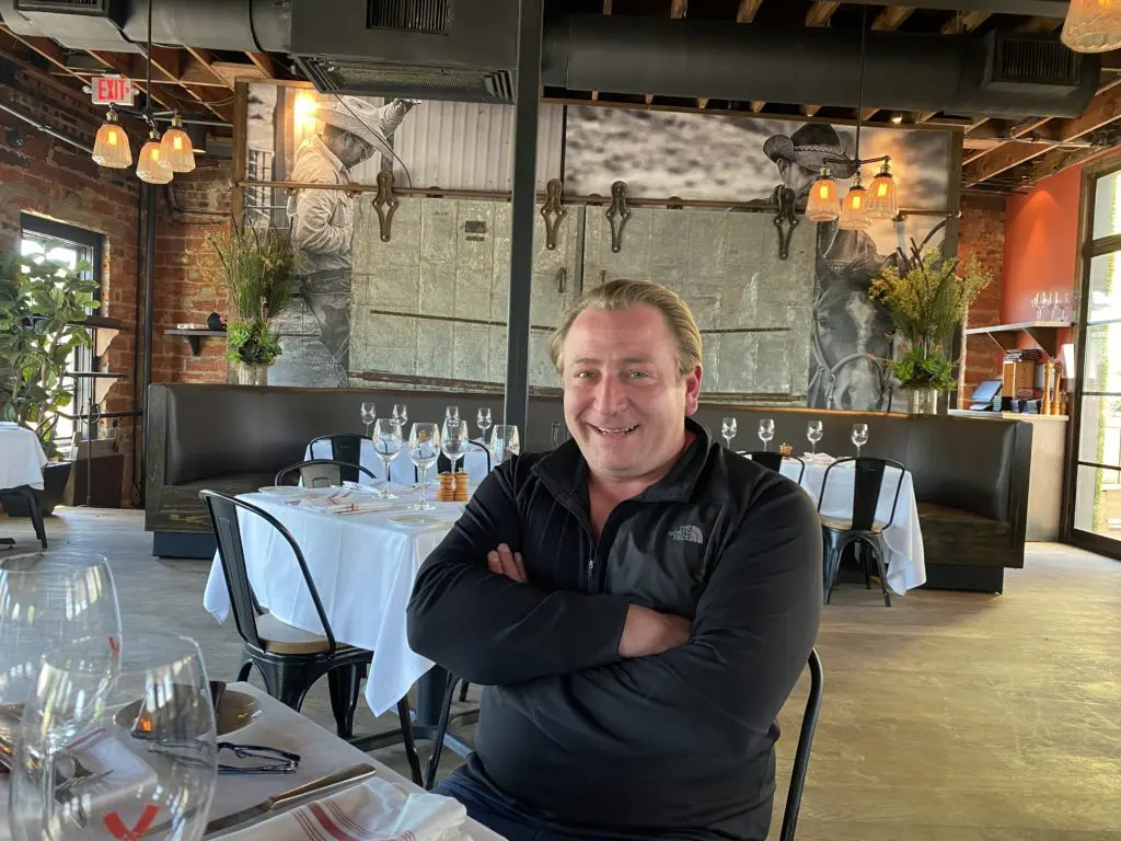 Benjamin Berg in the upstairs dining room at B&B Butchers where tables have been spread out for 25 percent occupancy. (Photo by Shelby Hodge)