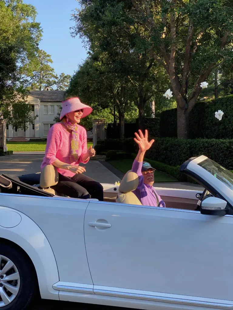 Shelby Hodge and Shafik Rifaat toss dozens of fresh gardenias into the air as a fragrant part of Sheridan Williams' drive-by birthday celebration in April. 
