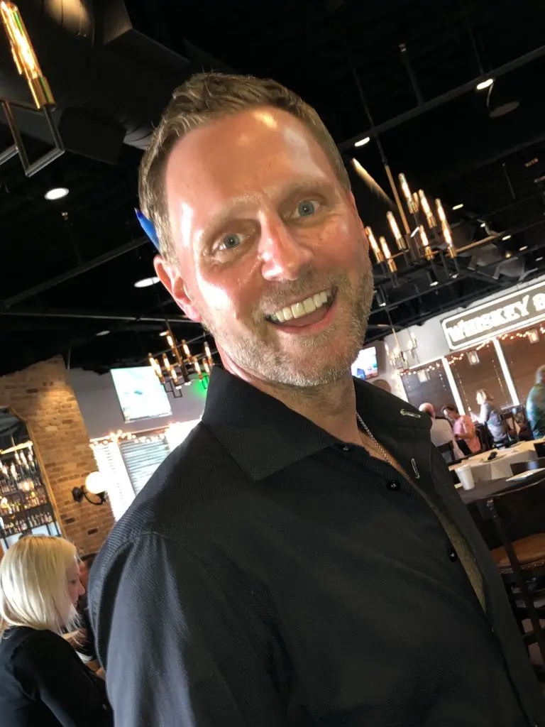 Matt Brice all smiles at the reopening of his Federal American Grill on the Katy Freeway, despite county orders to the contrary. (Photo by Judy Nichols)