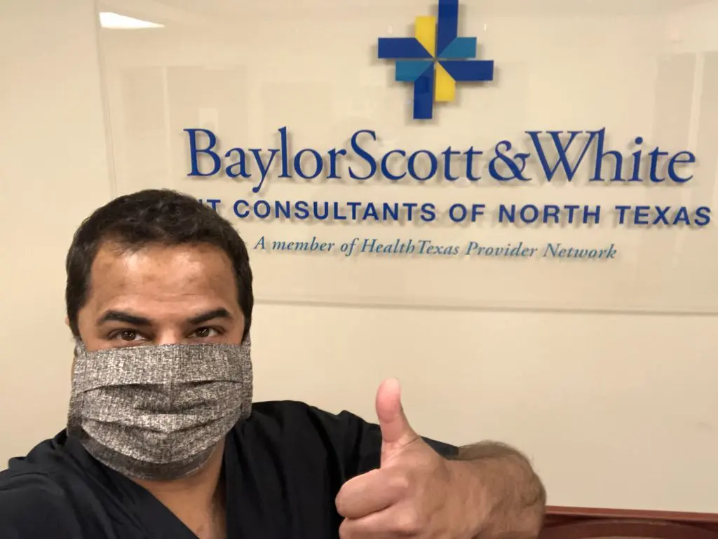 A hospital worker wearing a mask made by the refugees