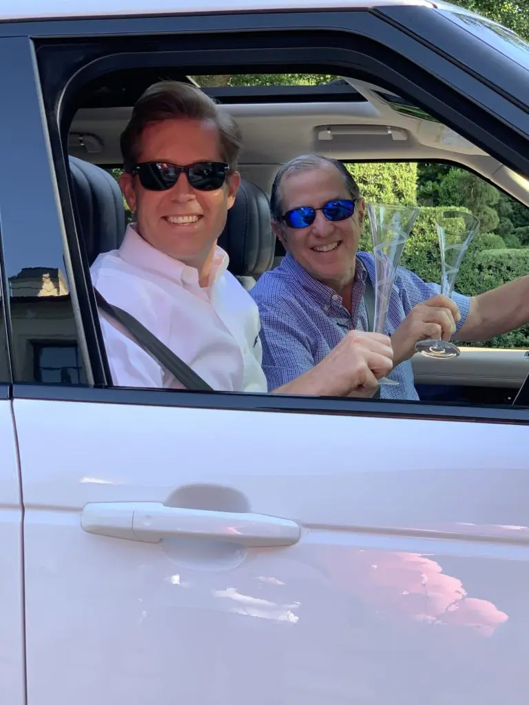 Partners John Furnish and Grant Kaiser offer drive-by birthday greetings.