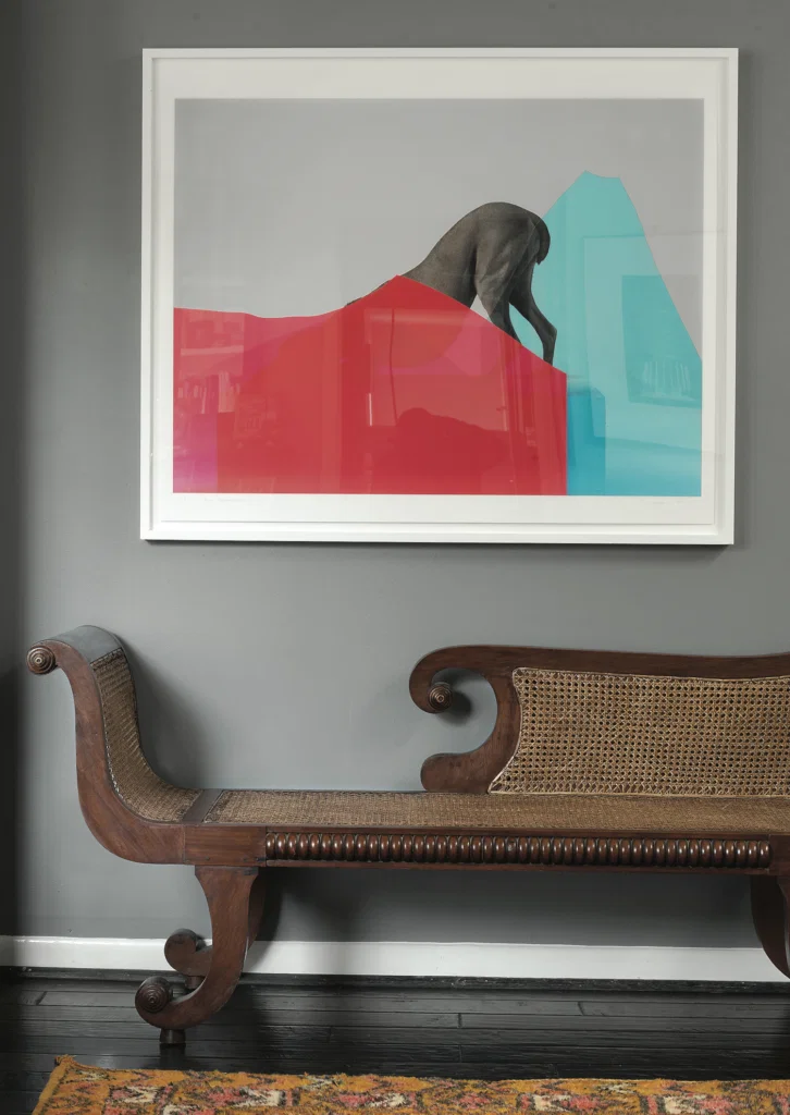 Ryan Gordon, published October 2014. Photographed by Jack Thompson. In architect Ryan Gordon’s 1981 Tom Wilson-designed townhome, rattan chaise longue and William Wegman’s "Peak Performance," 2010.