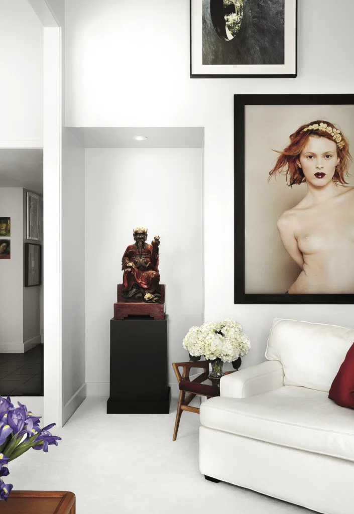 Mark Fehrs Haukohl, published November 2017. Photographed by Lisa Petrole. In Mark Fehrs Haukohl’s Houston high-rise, an antique temple figure acquired in Vietnam, photograph of Karen Elson by French photographer Bettina Rheims, Gio Ponti stool.
