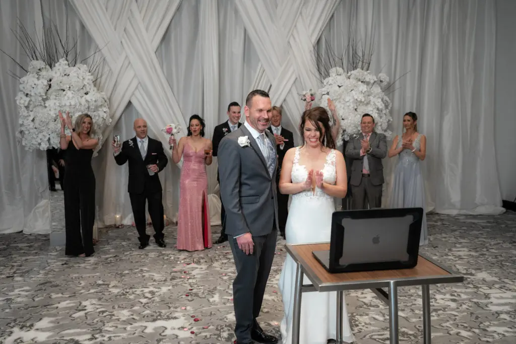 Tiffiny Scott and Clark Carroll review the video of their wedding that was posted live for friends and family. (Photo by Daniel Pawlowski, (www.theweddingshow.biz))
