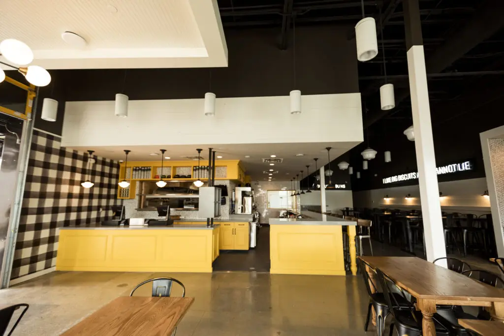 The store has a sunny interior, and two levels of patio dining.