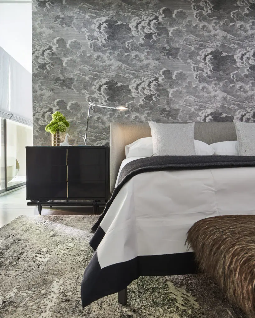 On the first level, the master-bedroom wallpaper is Fornasetti from Lee Jofa/ Brunschwig et Fils. Peacock Alley bedding. Kent Coffey side table from James McInroe. (Photo by Stephen Karlisch)