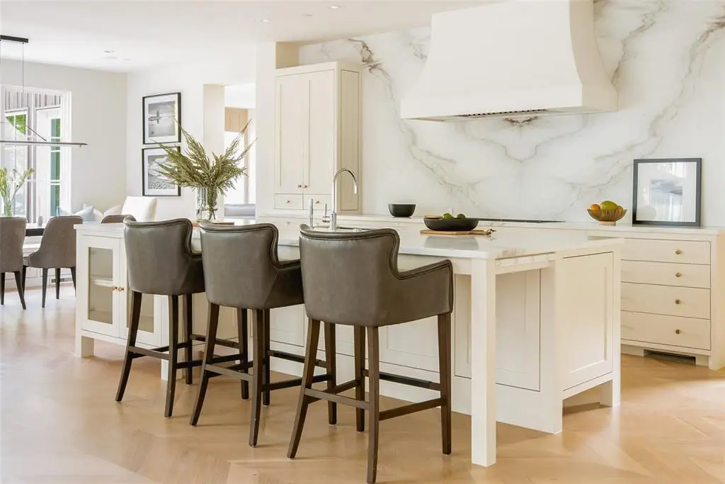A white marble filled kitchen.  (Photo by Compass Real Estate)