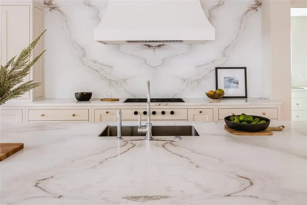 A white marble filled kitchen.  (Photo by Compass Real Estate)