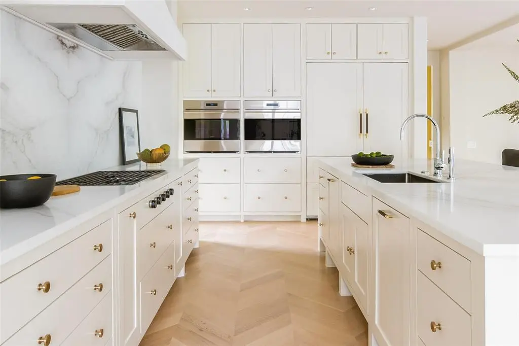 A white marble filled kitchen.  (Photo by Compass Real Estate)