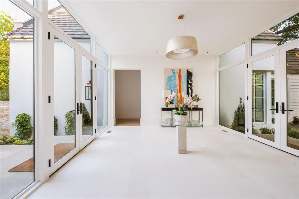 An easy-on-the-eyes blend of natural materials and an excess of natural light help keep the outdoors in. (Photo by Compass Real Estate)
