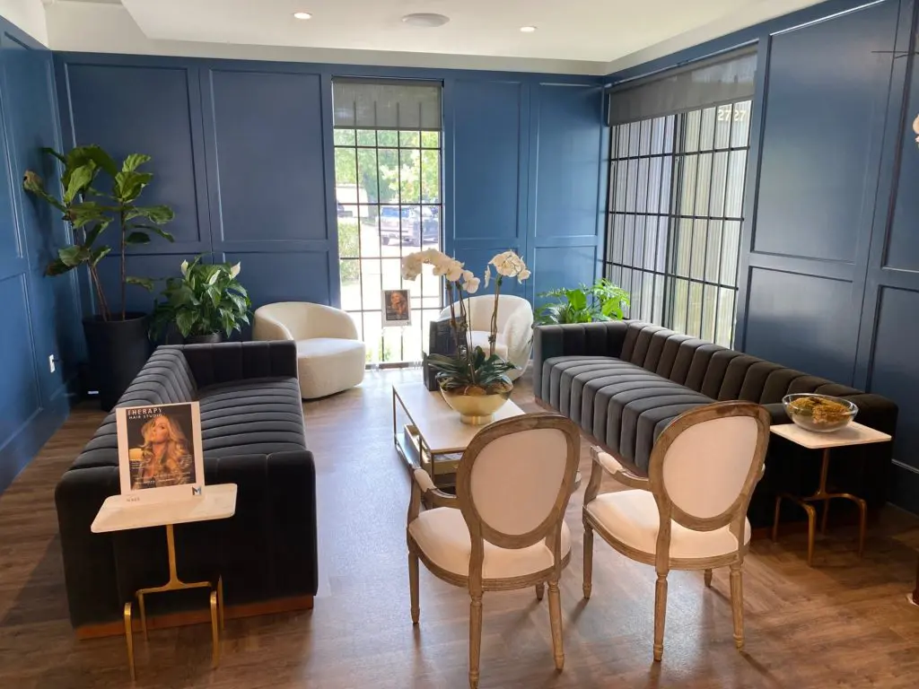 The sleek lounge at the new Therapy Hair Studio will remain empty as long as coronavirus protocols remain in place. (Photo by Shelby Hodge)