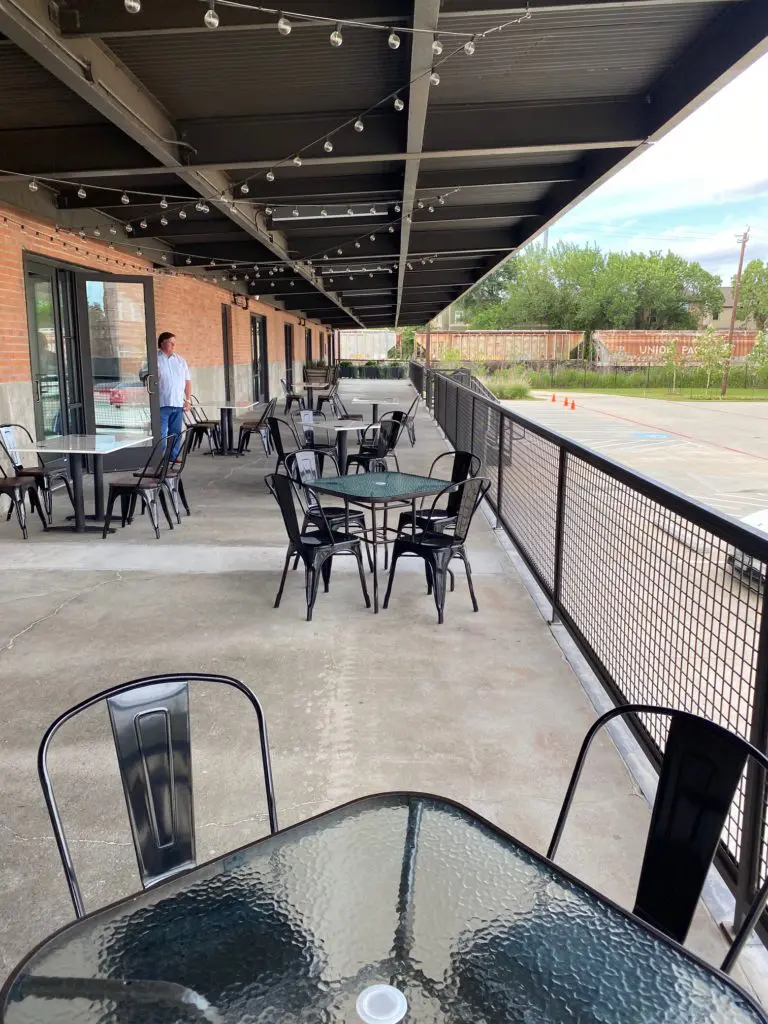 Bill Floyd overlooks the vast patio that backs up to the railroad track, an added dimension to the restaurant ambience. (Photo by Shelby Hodge)