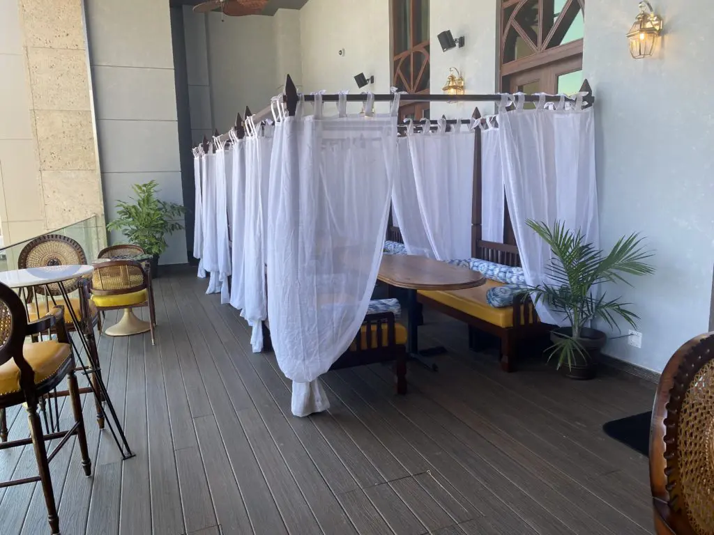 The outdoor lounge at Musaafer is complimented by daybeds draped colonial style in linen and featuring plump bolsters. (Photo by Michael Anthony)