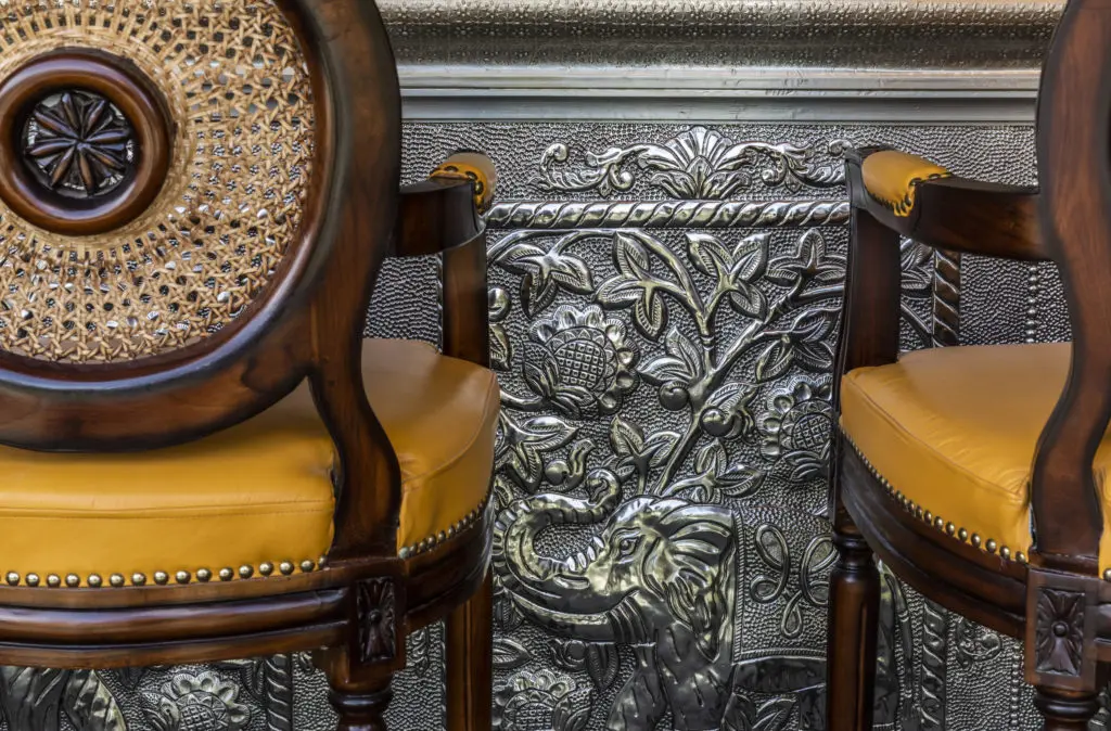 Hand-hammered artistic tin panels line the bar of Musaafer, located on the second floor of The Galleria above Fig & Olive. (Photo by Julie Soefer)