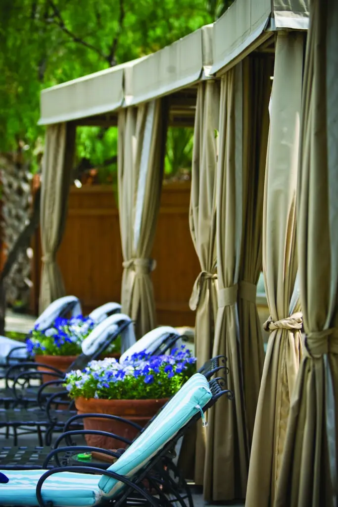 Cabanas by the Palm Pool offer inviting relaxation for both tanning and secluded relaxation. (Photo by Lake Austin Spa Resort)