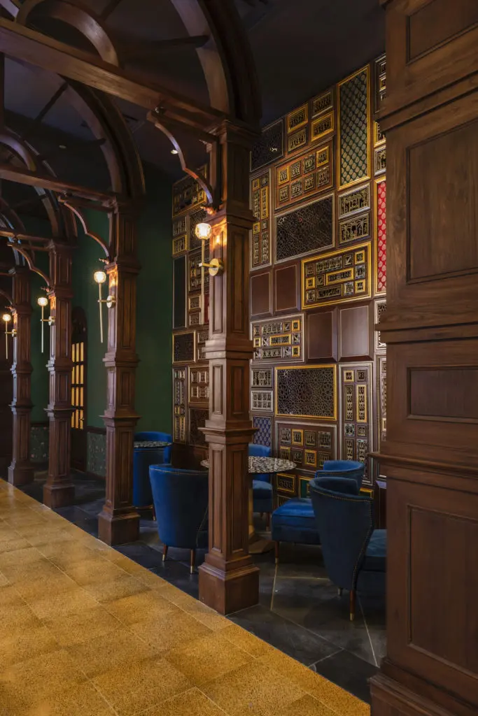 In The Traveler's Room, a 25-foot-long Dhokra wall featuring brass castings of folk motifs is framed by 16-foot carved wooden colonnades. (Photo by Julie Soefer)