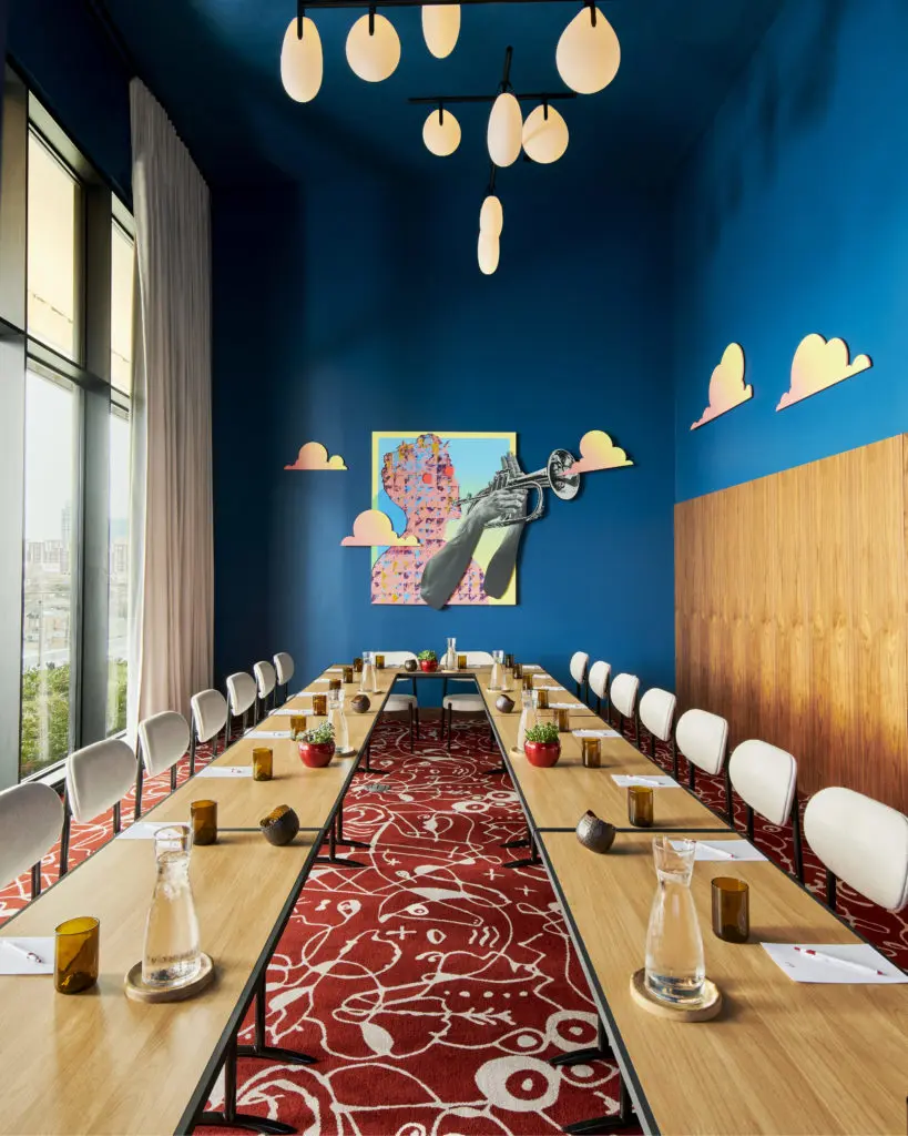 A meeting room designed by Swoon, the Studio makes guests feel as if they’re floating in the clouds with custom artwork that plays off the incredible views. “Hotel carpet tends to be either prosaic and boring or garish and over the top,” says Joslyn Taylor, partner and designer at Swoon. “We wanted to create something fun and cheeky that felt really specific to the hotel. "We came up with the idea of a Texas cliché carpet that we designed in the studio. We included subtle illustrations of common Dallas stereotypes hidden throughout a Joan Miró-inspired pattern. Look closely, and you’ll find oil derricks, money, cowboy hats, and cans of hairspray, among other surprises.” 