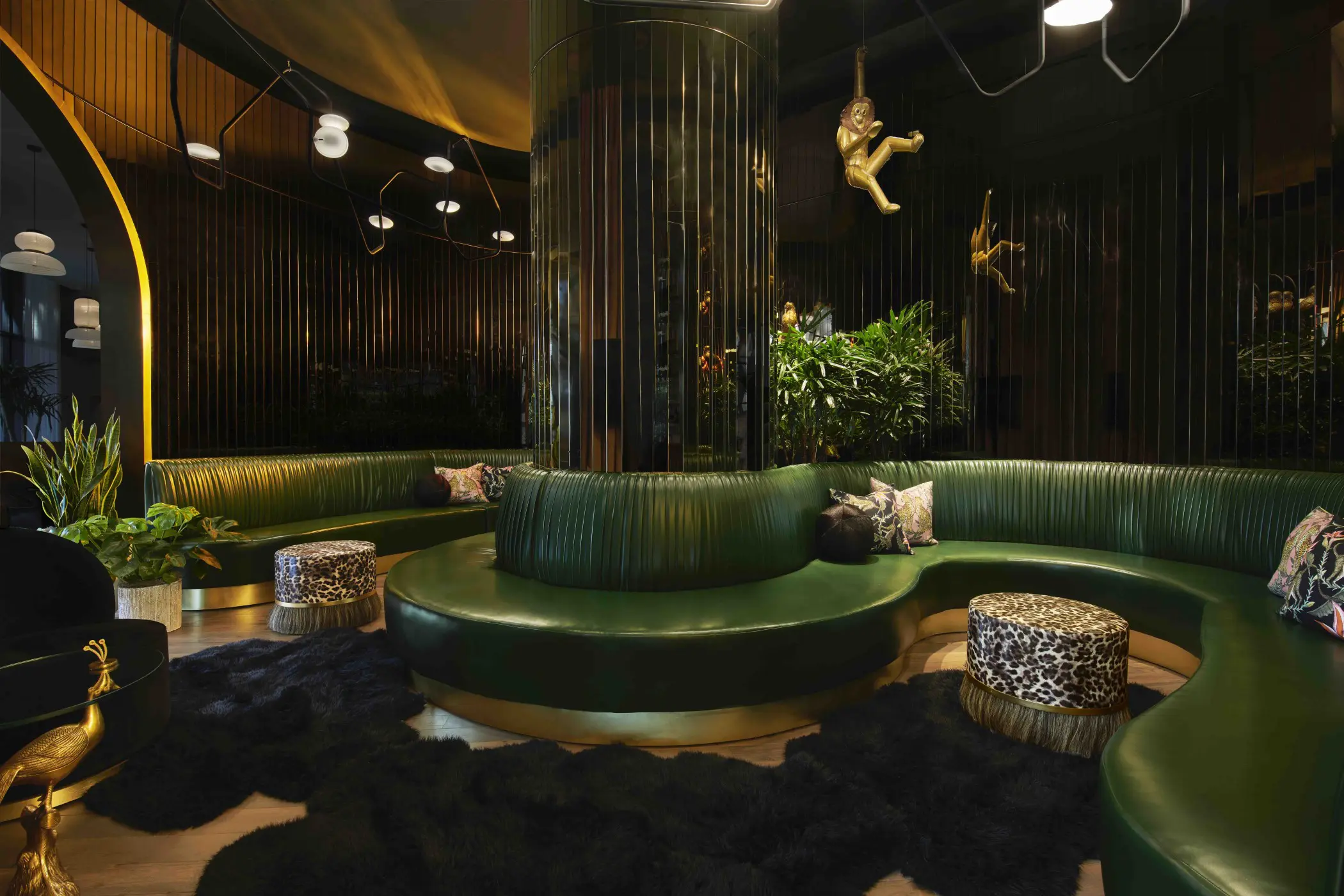 Mozersky channeled Studio 54 with smoked mirrored walls to reflect and move the light around the dark space. Kinetic chandeliers by Rich Brilliant Willing add a sculptural element. Black sheepskin rugs and leopard-print and horsehair fringed ottomans add to the fun.
“We found a monkey and two parrot sculptures by the famous Mexican artist Sergio Bustamante to give the room a little wink,” he says. 