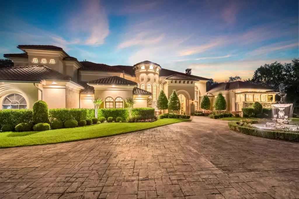 French limestone fountain in the roundabout of this Mediterranean home.