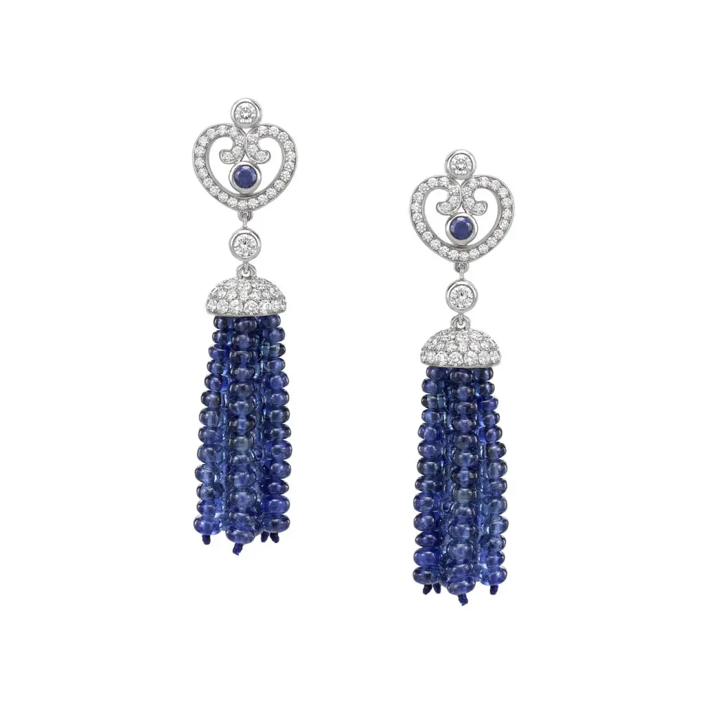 Impératrice Sapphire tassel earrings feature round sapphire center stones surrounded by white diamonds, with a tassel of sapphire beads, set in 18 karat white gold.