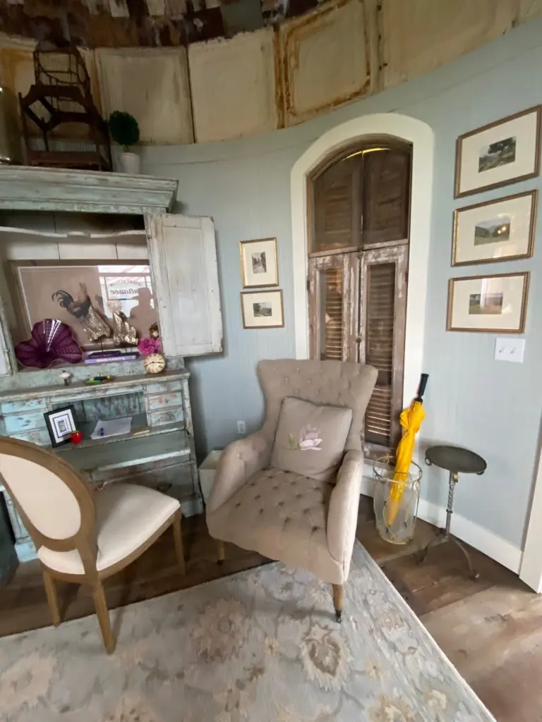 The weathered antique secretary is the decorative focal point in the silo living room. (Photo by Shafik I. Rifaat)