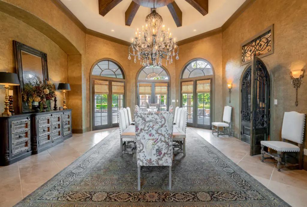 The formal dining room looks out onto the patio and water features.