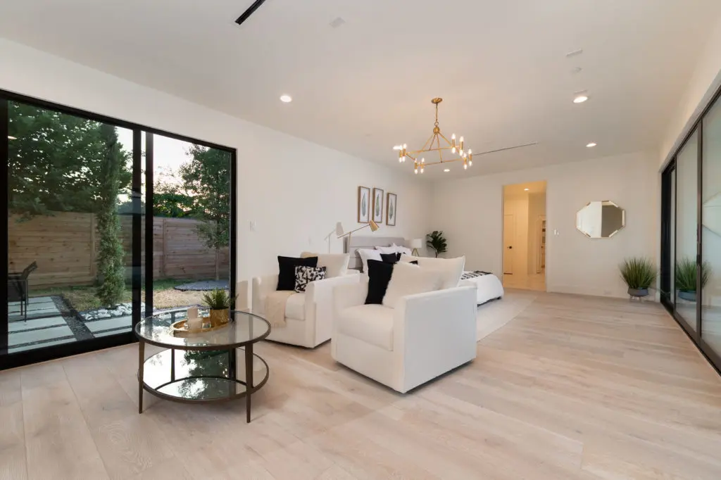 The primary bedroom with its sitting and private patio.